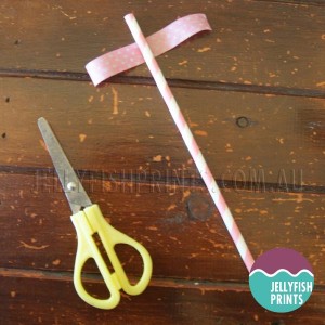 Cut the tape and attach it to the drinking straw.